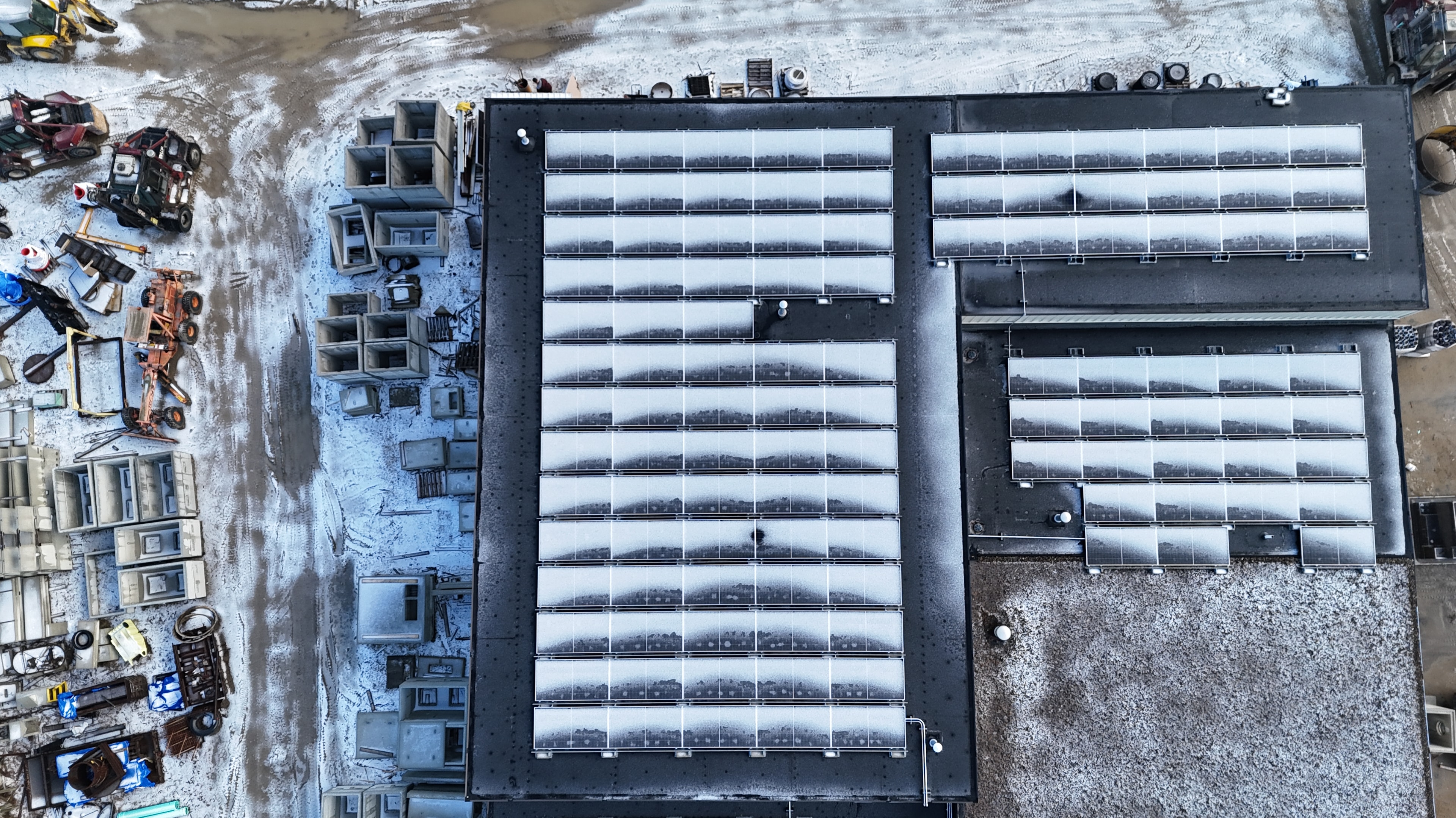 Aerial view of Phoenix Precast commercial rooftop solar installation in winter
