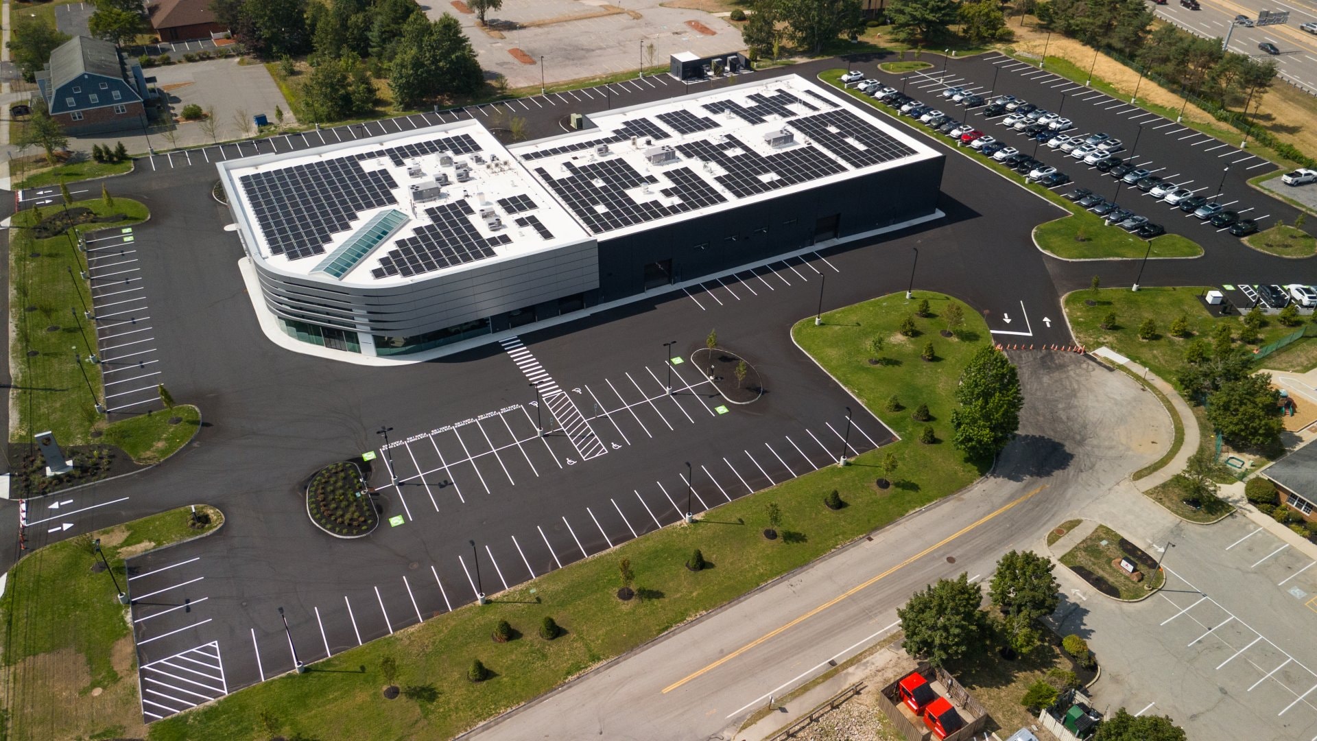 Aerial view of Porsche Dealership rooftop solar installation, Nashua, NH