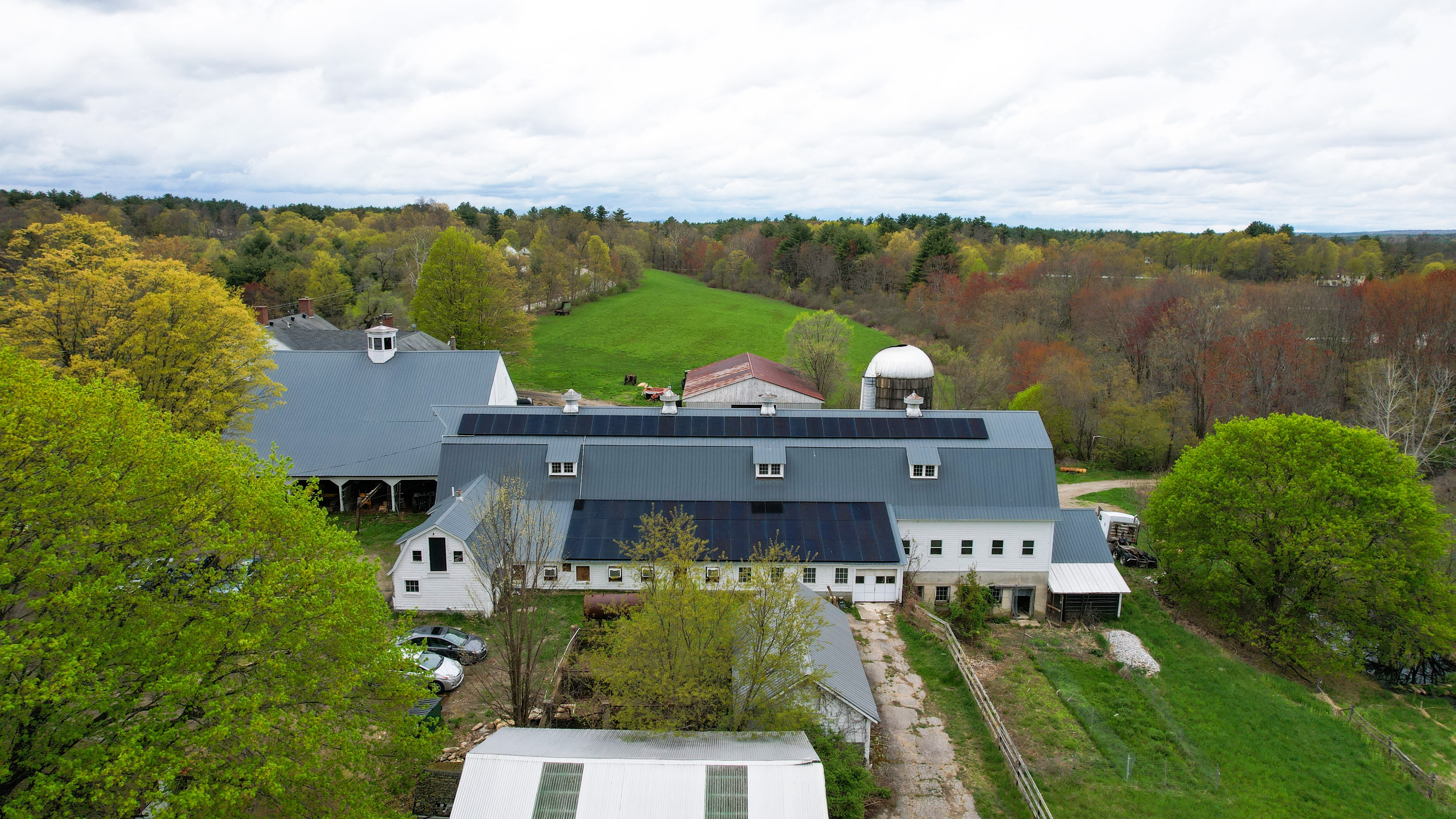 Aerial view of Upswing Farm barn rooftop solar installation, Pepperell, MA