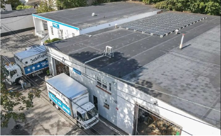 Solar-powered moving company warehouse with electric trucks